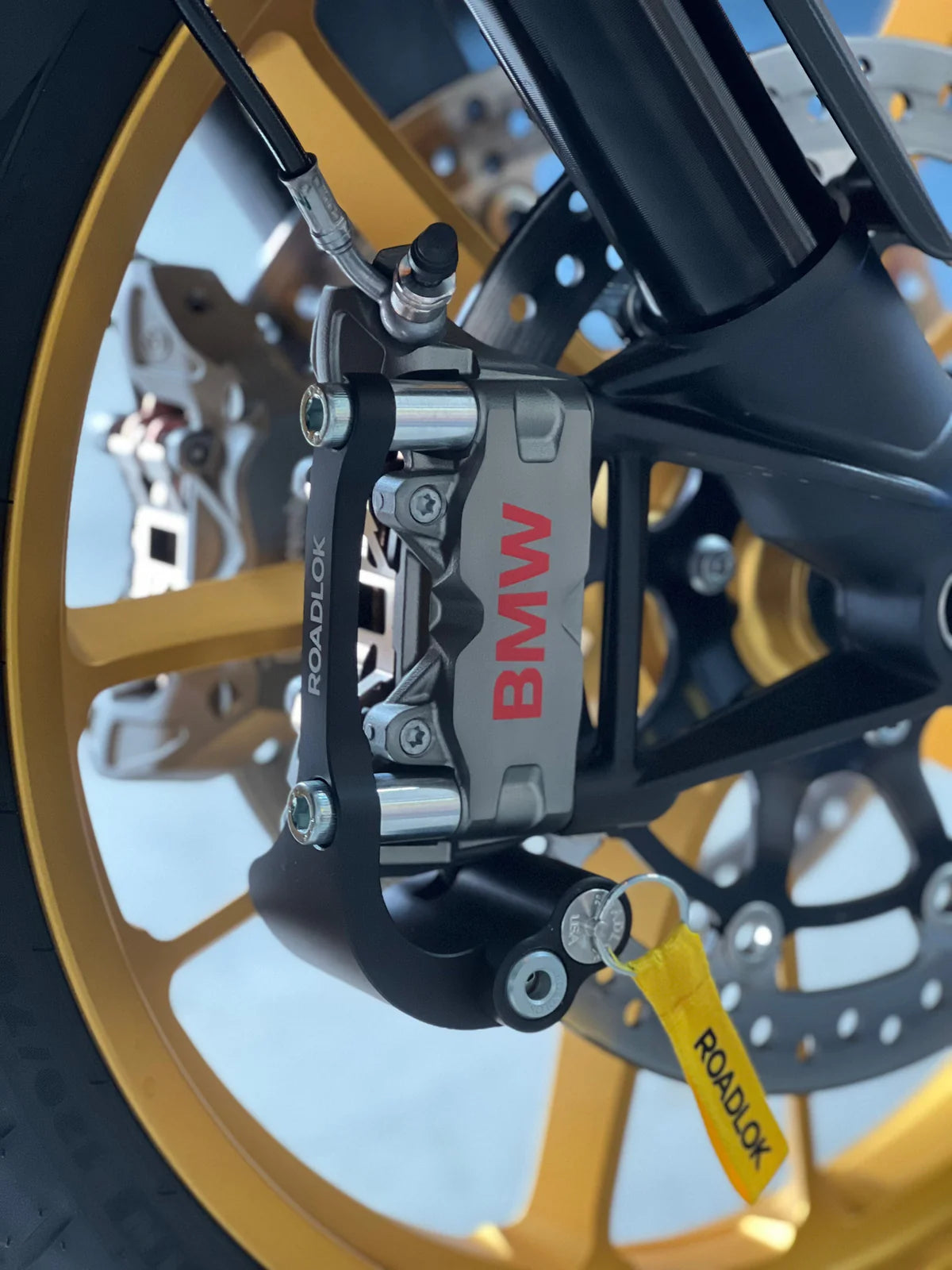 Roadlok XRA Eurosport ART4 100mm disk lock for BMW R1300GS, R1250GS, and 1200 LC motorcycle, showing the right-side lock in black.