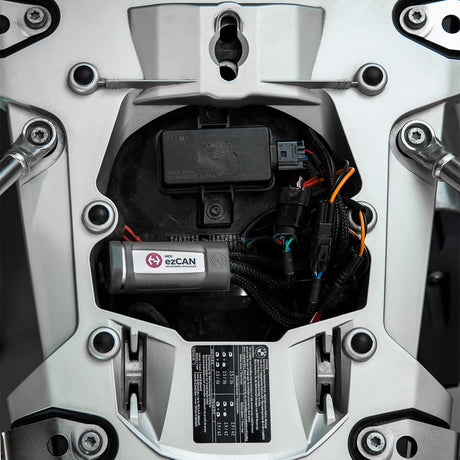 Hex Innovate adventure silicone sleeve installed on ezCAN Cansmart device under motorcycle seat for protection and durability.