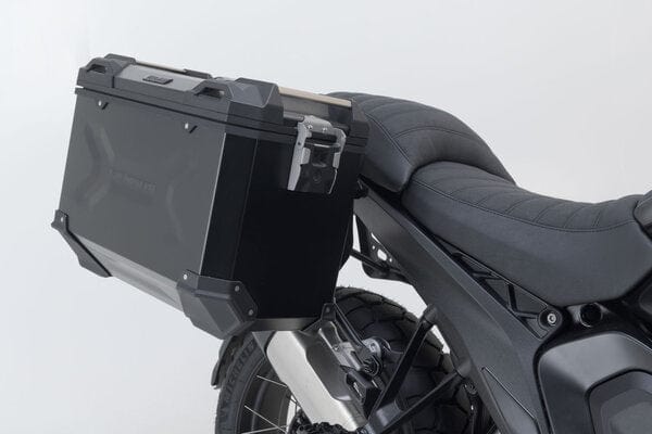 SW-Motech Trax Adventure luggage set for BMW R1300GS motorcycle, durable hard cases with black finish and secure mounting system.
