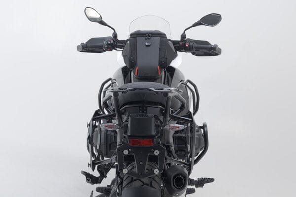 SW-Motech Trax Adventure luggage set for BMW R1300GS motorcycle, durable black panniers and top case on bike side view.
