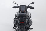 SW-Motech Trax Adventure luggage set for BMW R1300GS motorcycle, durable black panniers and top case on bike side view.